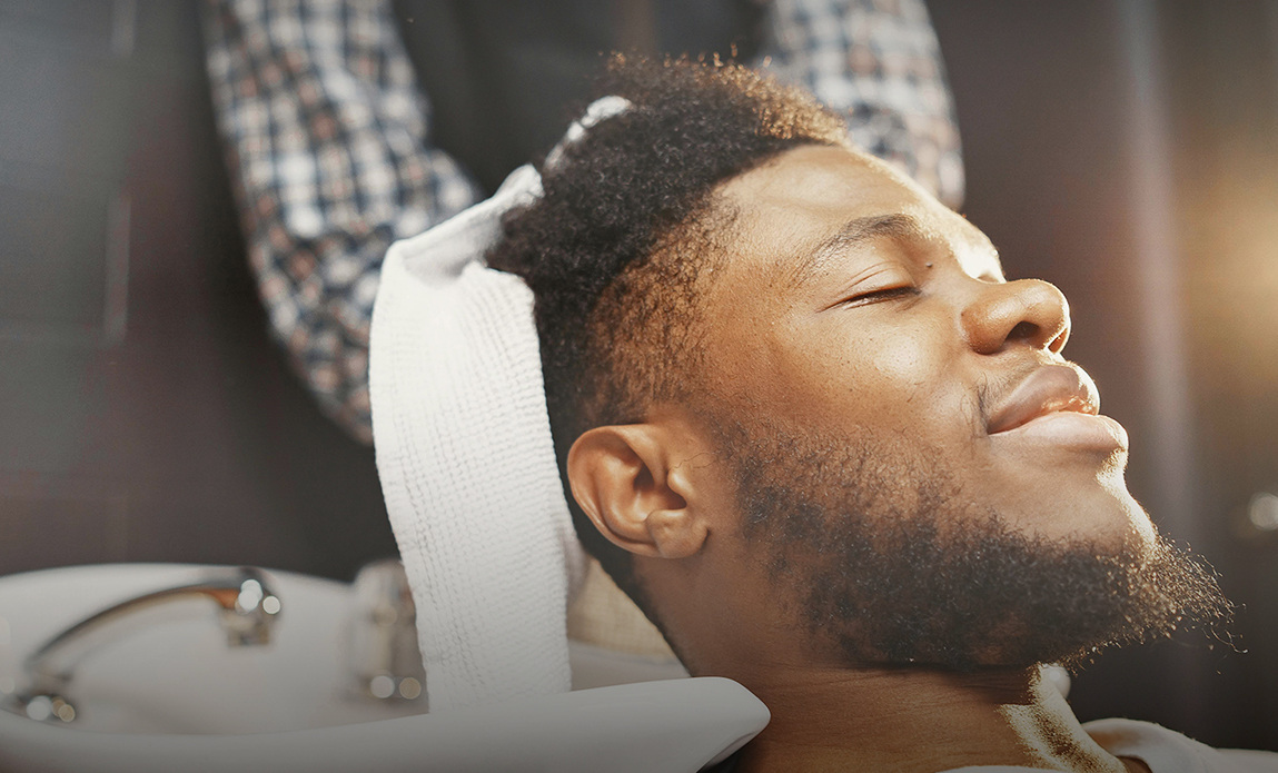 Client relaxing during a hot towel treatment