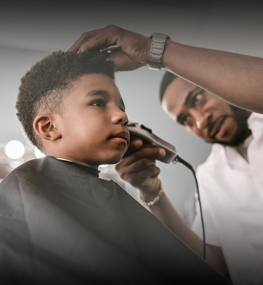 Barber giving a young boy a haircut